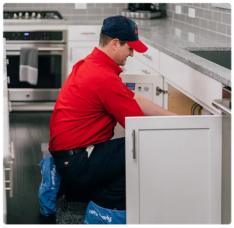 Plumber working on a sink